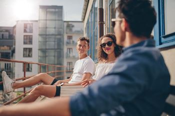 a group of people sitting on a balcony